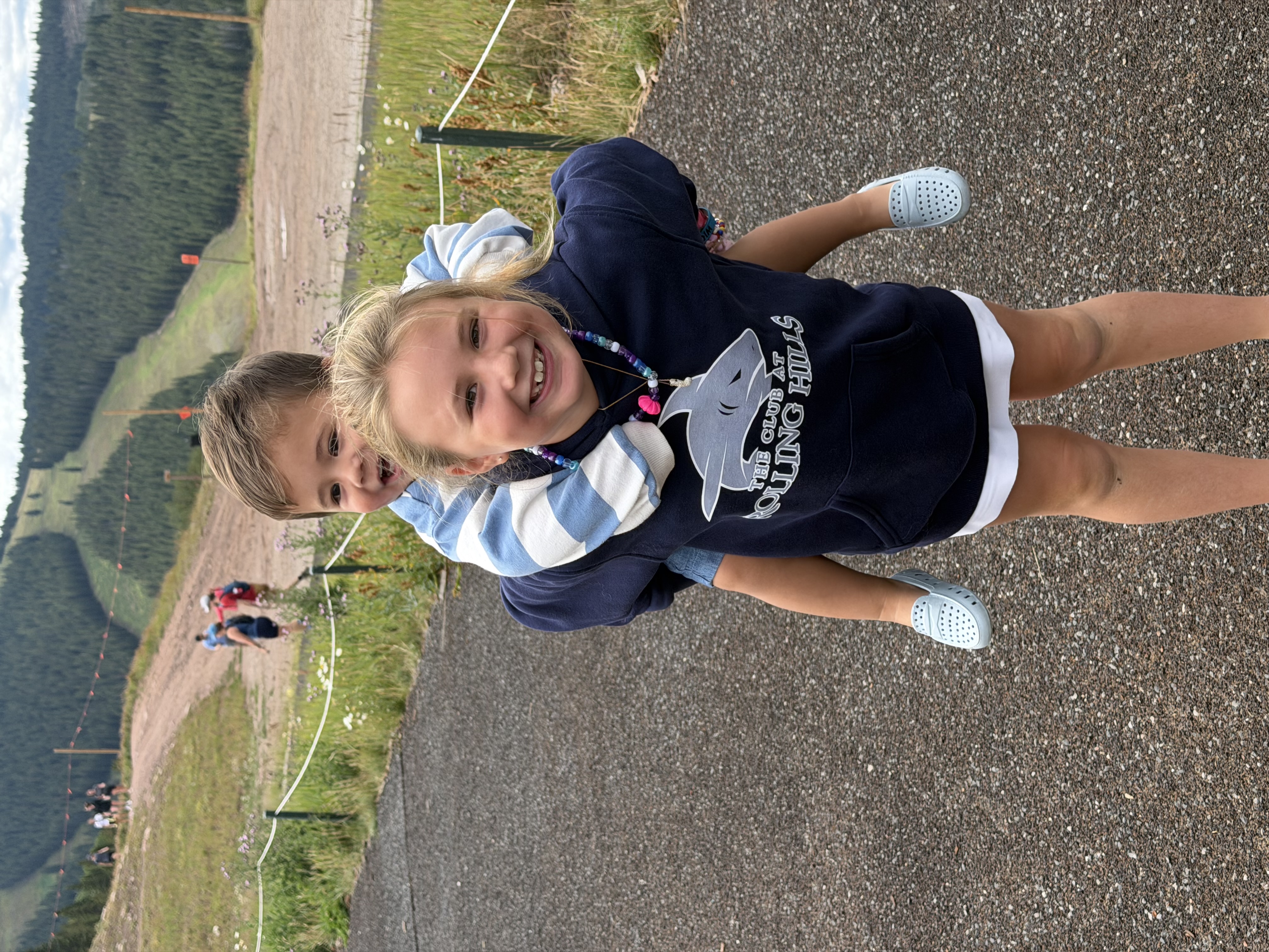 Lily giving her little brother a piggyback ride in the mountains